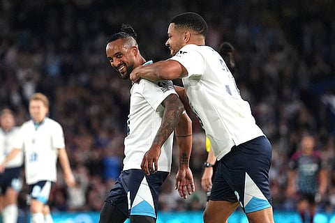 Theo Walcott, left, celebrates scoring their side's sixth goal 
